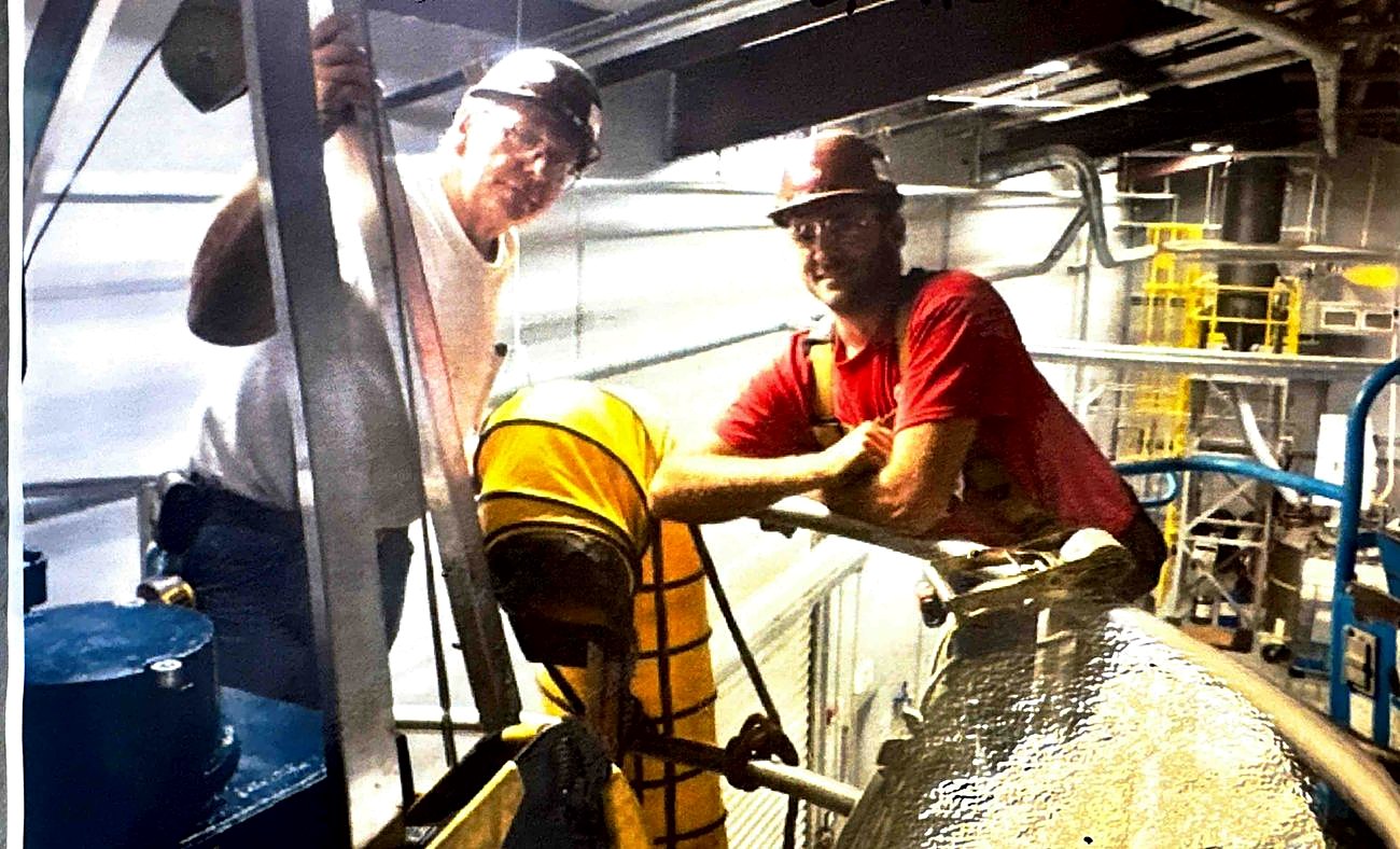 Paul Brewer and Harrison Balzli installing a polymer tank