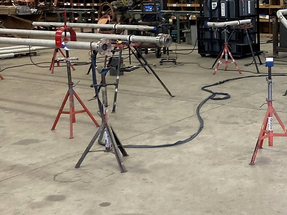 Stainless spools on pipe stands in the shop