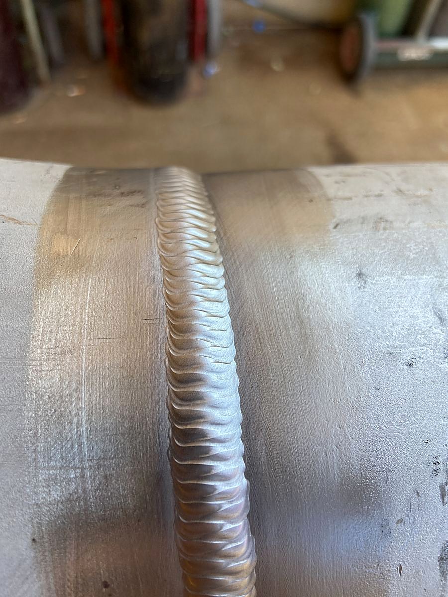 Close-up of a finished stainless steel weld